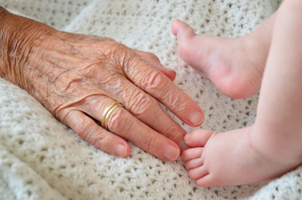 elderly hand and baby feet