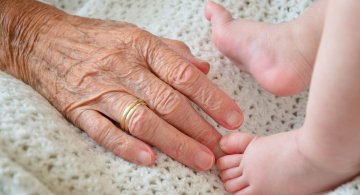 elderly hand and baby feet